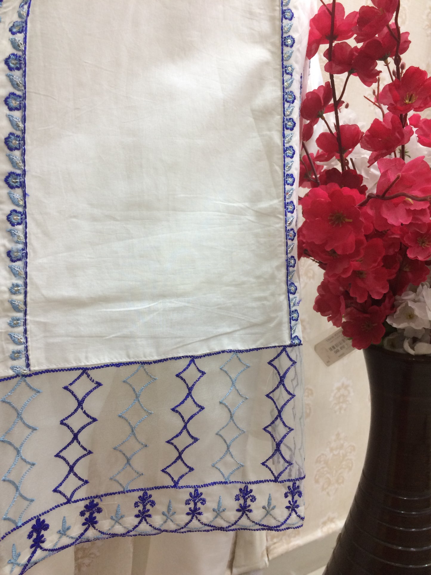 White dress blue thread work dress airport