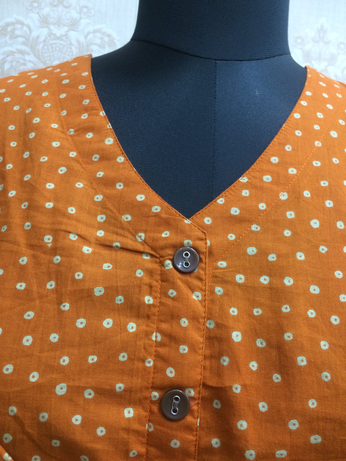 Orange short tunic brown button